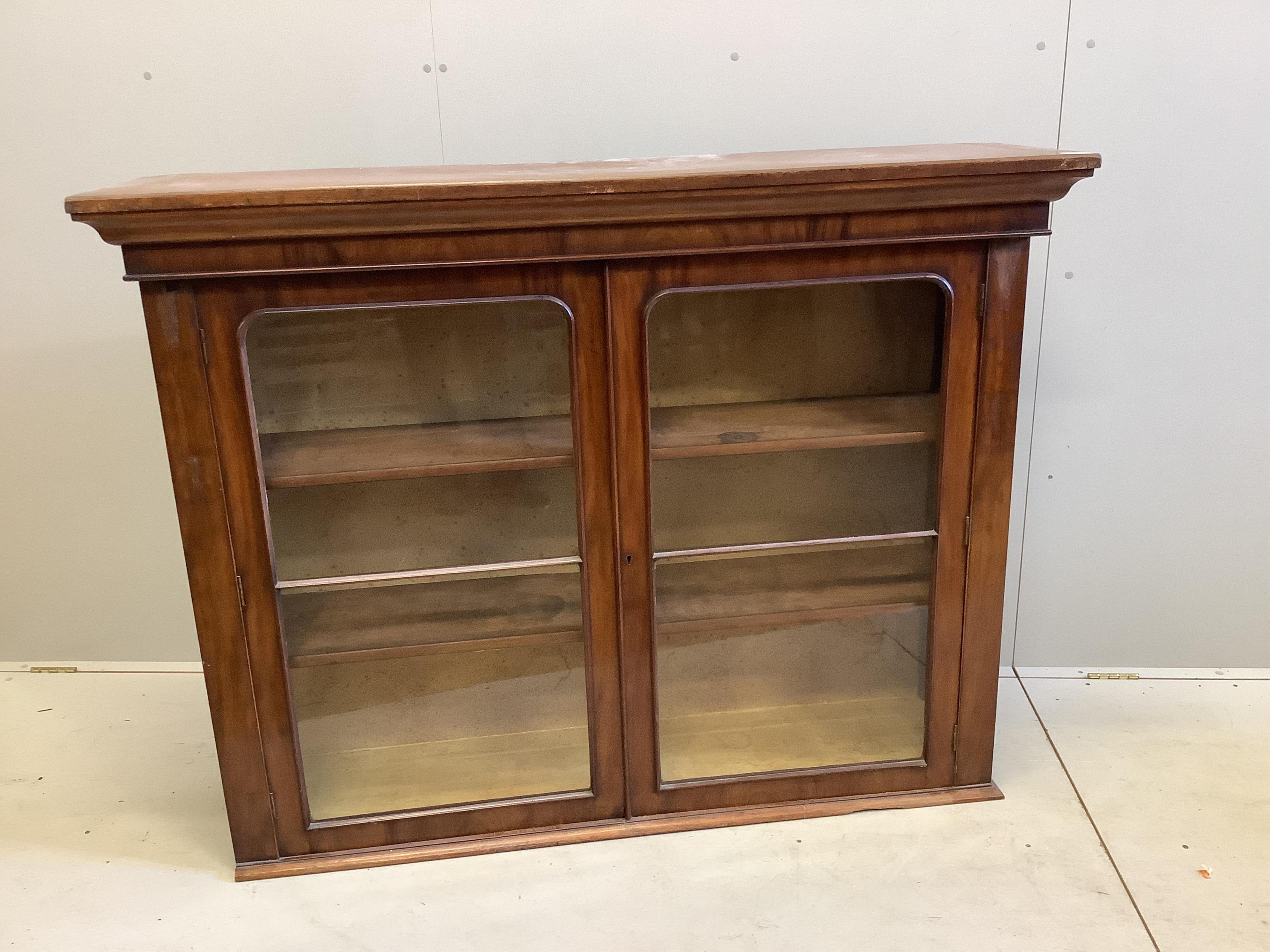 A Victorian mahogany bookcase, adapted, fitted with a pair of glazed doors, width 149cm, depth 38cm, height 116cm. Condition - fair